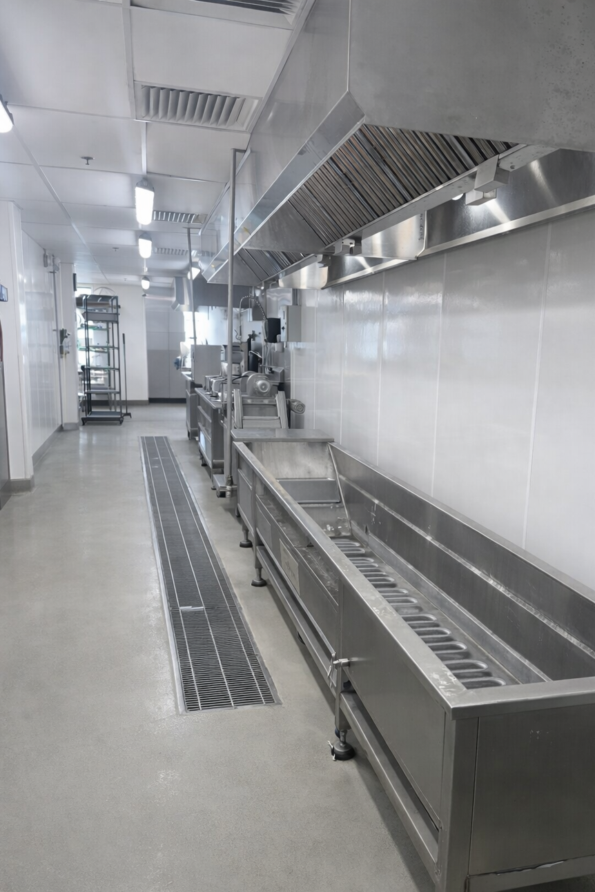 Stainless steel kitchen equipment in a commercial kitchen setting